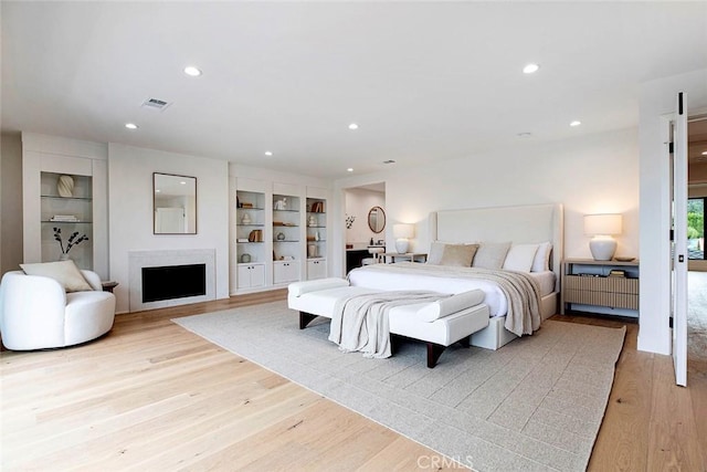 18101 Green Meadow Dr, Encino, CA 91316 - bedroom with light wood finished floors, recessed lighting, and a fireplace