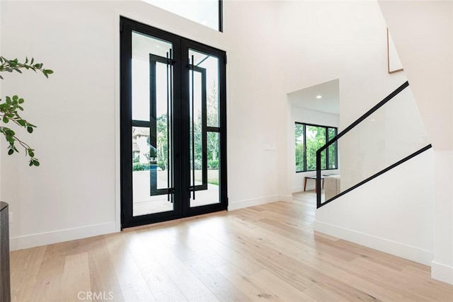18101 Green Meadow Dr, Encino, CA 91316 - entrance foyer featuring french doors, light wood-style floors, baseboards, a high ceiling, and stairs