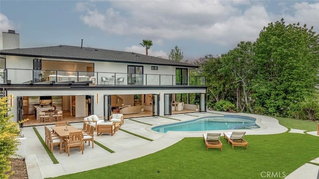 18101 Green Meadow Dr, Encino, CA 91316 - rear view of house featuring a balcony, outdoor lounge area, a patio, and a lawn