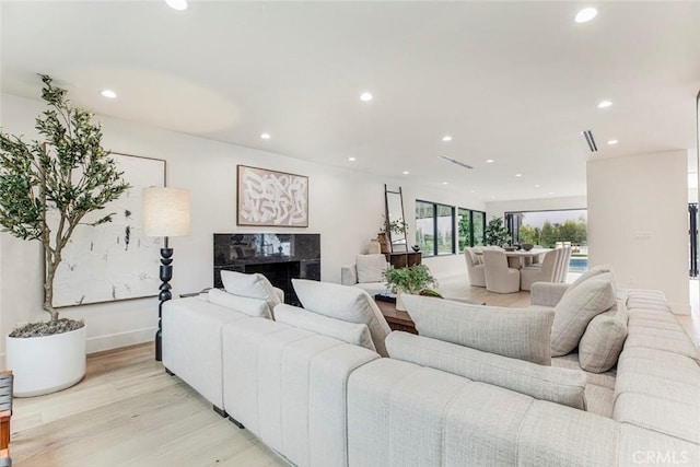 18101 Green Meadow Dr, Encino, CA 91316 - living room with recessed lighting, light wood-style floors, a premium fireplace, and baseboards