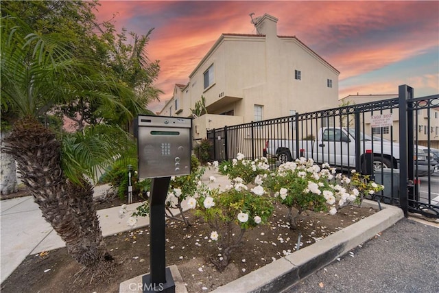 property exterior at dusk featuring fence
