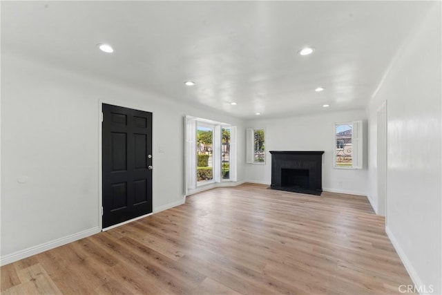 2150 N Eastern Ave, Los Angeles, CA 90032 - unfurnished living room featuring a fireplace, recessed lighting, light wood-style flooring, and baseboards