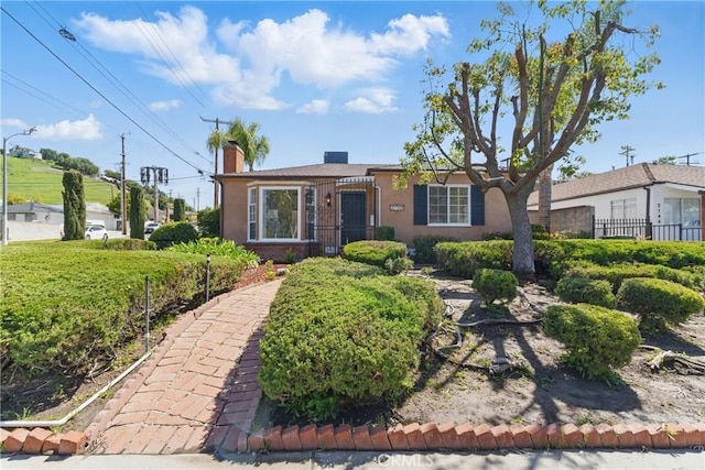 2150 N Eastern Ave, Los Angeles, CA 90032 - view of front of home featuring a chimney, stucco siding, and fence
