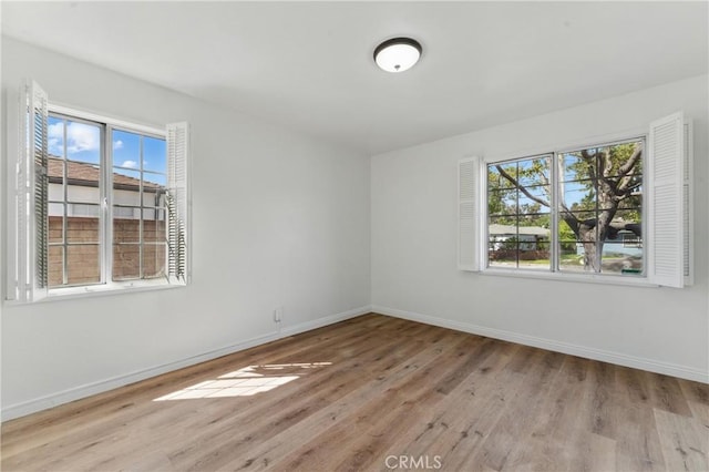 2150 N Eastern Ave, Los Angeles, CA 90032 - spare room featuring healthy amount of natural light, wood finished floors, and baseboards