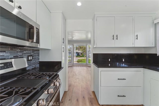2150 N Eastern Ave, Los Angeles, CA 90032 - kitchen featuring appliances with stainless steel finishes, dark countertops, tasteful backsplash, white cabinets, and recessed lighting