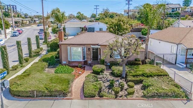 2150 N Eastern Ave, Los Angeles, CA 90032 - bungalow-style house with fence, a chimney, a residential view, stucco siding, and brick siding