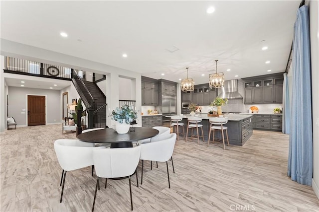 dining space featuring recessed lighting, a chandelier, baseboards, and stairway