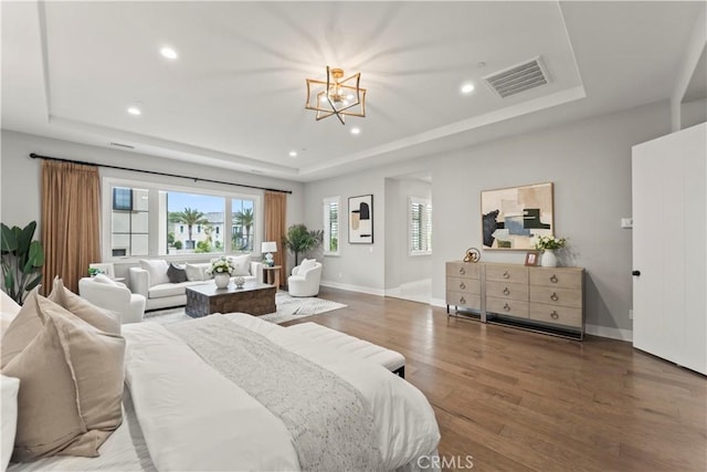 bedroom with a raised ceiling, a chandelier, wood finished floors, recessed lighting, and baseboards