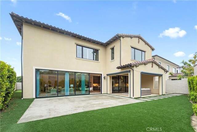 rear view of house featuring a patio and stucco siding