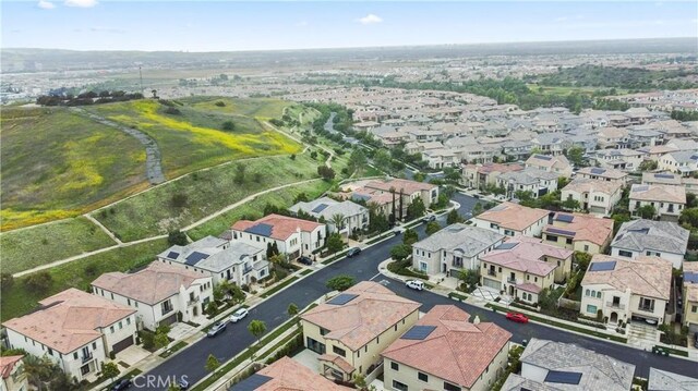 aerial view of property and surrounding area featuring nearby suburban area