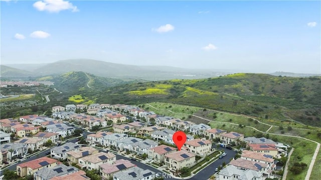 aerial overview of property's location with a mountainous background and nearby suburban area