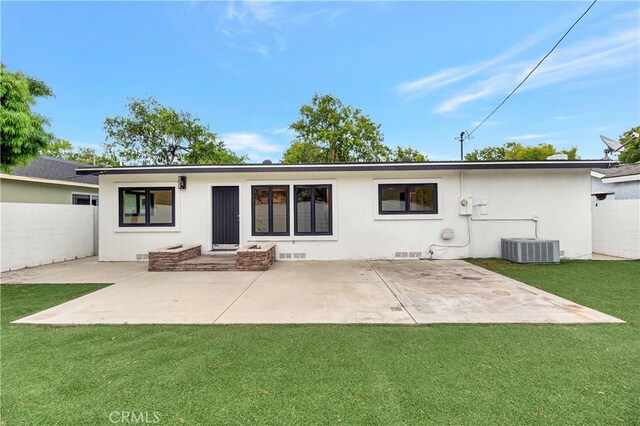 rear view of house with stucco siding, a patio area, and central air condition unit