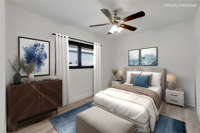 bedroom with light wood-style floors, baseboards, and a ceiling fan