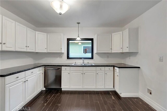 kitchen with a sink, dishwasher, dark countertops, and white cabinetry