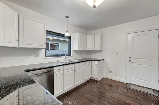kitchen with a sink, stainless steel dishwasher, and white cabinetry