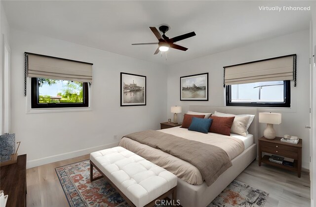 bedroom featuring light wood-type flooring and baseboards