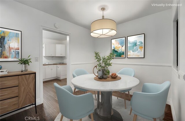 dining space with wood finished floors and baseboards
