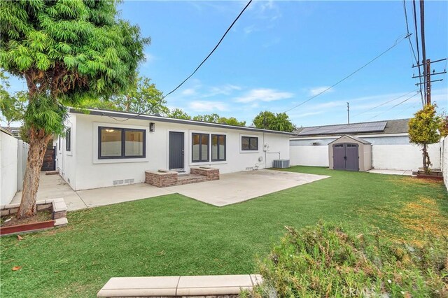 back of property featuring a storage unit, a patio area, stucco siding, an outdoor structure, and central air condition unit
