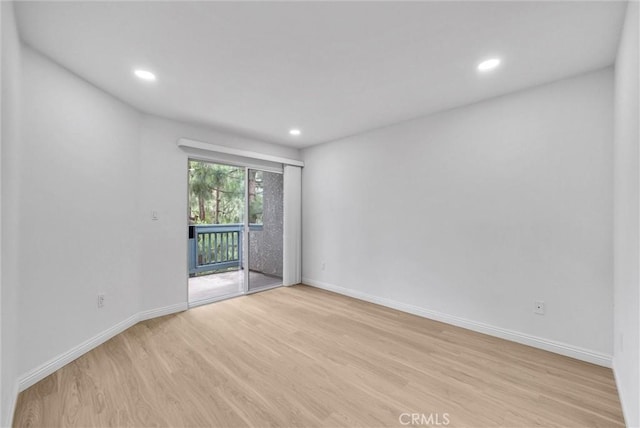 spare room with light wood-style floors, baseboards, and recessed lighting