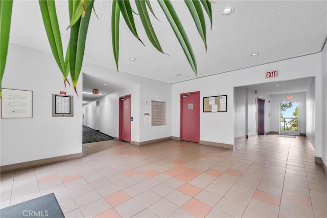 common area featuring a textured ceiling and recessed lighting