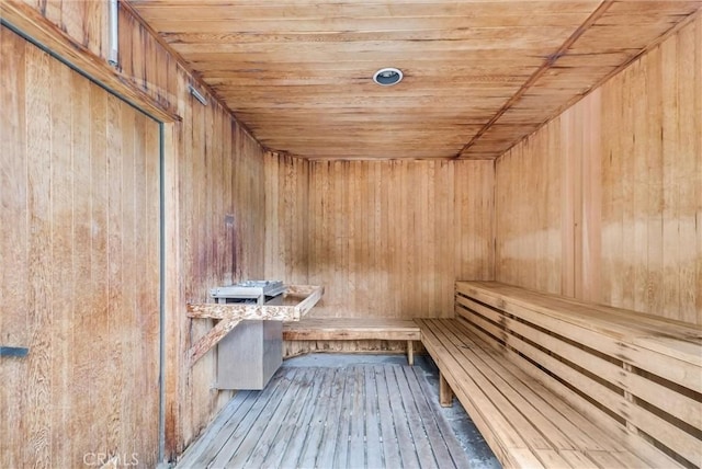 relaxing sauna / steam room featuring wood ceiling, wood walls, and hardwood / wood-style flooring
