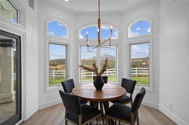 34105 Stage Rd, Temecula, CA 92592 - dining area with a chandelier, healthy amount of natural light, light wood-style flooring, baseboards, and ornamental molding