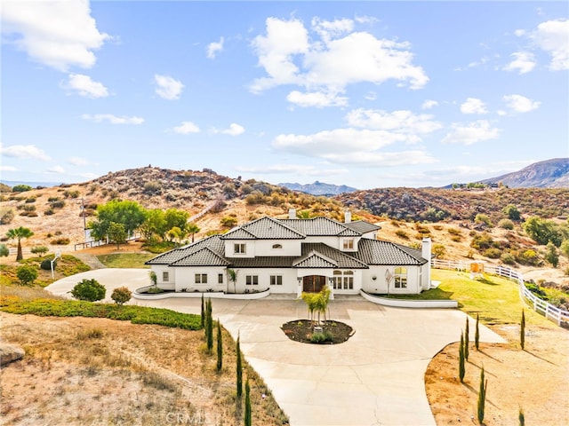 34105 Stage Rd, Temecula, CA 92592 - view of front of home with a chimney, a mountain view, a tiled roof, stucco siding, and fence