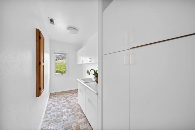34105 Stage Rd, Temecula, CA 92592 - bathroom featuring a sink and baseboards