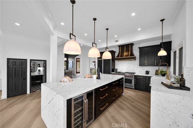 34105 Stage Rd, Temecula, CA 92592 - kitchen featuring high end stove, premium range hood, recessed lighting, a large island, and decorative backsplash