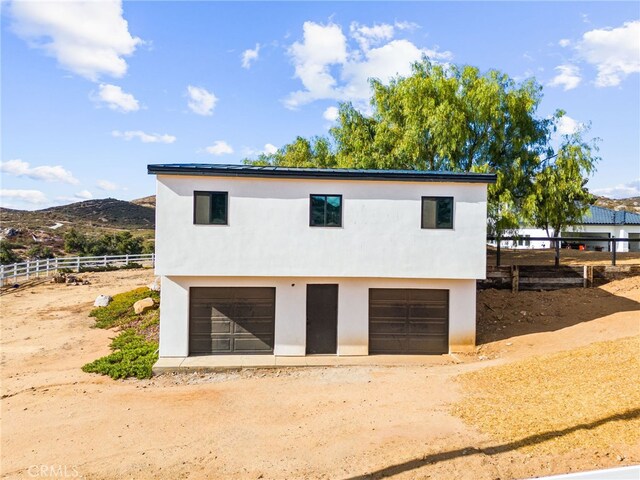 34105 Stage Rd, Temecula, CA 92592 - garage featuring fence, driveway, and a mountain view