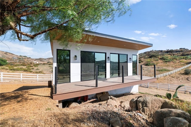 34105 Stage Rd, Temecula, CA 92592 - view of home's exterior with a deck, fence, and stucco siding