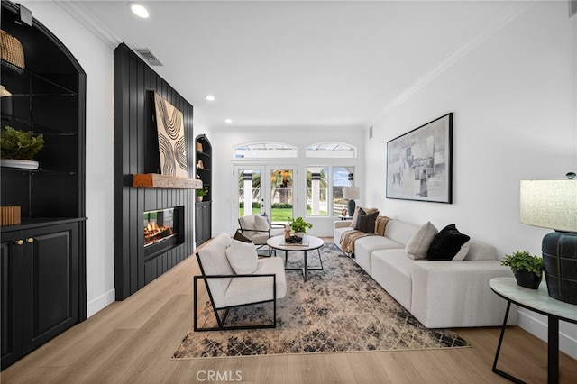 34105 Stage Rd, Temecula, CA 92592 - living room with crown molding, a large fireplace, wood finished floors, and recessed lighting
