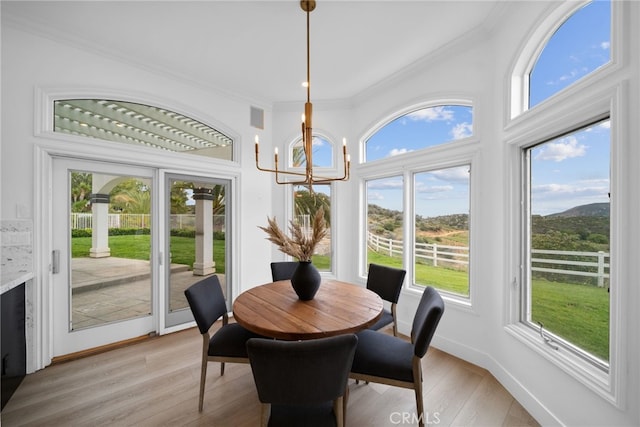 34105 Stage Rd, Temecula, CA 92592 - dining space with crown molding, a chandelier, light wood-type flooring, and baseboards
