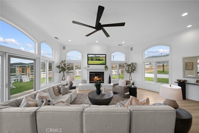 34105 Stage Rd, Temecula, CA 92592 - living room featuring light wood-style floors, a high end fireplace, recessed lighting, a ceiling fan, and ornamental molding