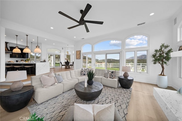 34105 Stage Rd, Temecula, CA 92592 - living room featuring light wood finished floors, ornamental molding, ceiling fan, recessed lighting, and baseboards
