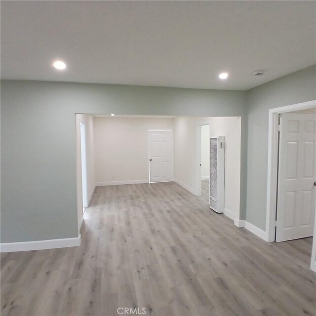 5109 S 7th Ave, Los Angeles, CA 90043 - empty room with a heating unit, recessed lighting, light wood-type flooring, and baseboards