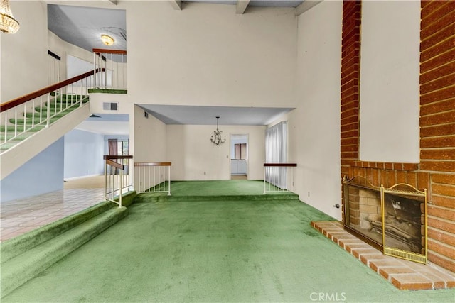 22244 Croll Ct, Diamond Bar, CA 91765 - unfurnished living room featuring carpet, a towering ceiling, a fireplace, and a chandelier