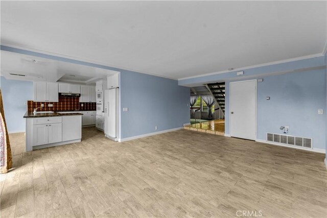 22244 Croll Ct, Diamond Bar, CA 91765 - unfurnished living room featuring baseboards, crown molding, light wood-style flooring, and stairway