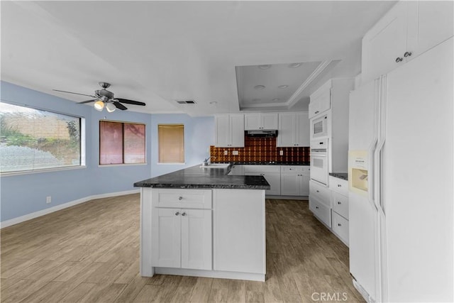 22244 Croll Ct, Diamond Bar, CA 91765 - kitchen with white appliances, a raised ceiling, under cabinet range hood, white cabinets, and a ceiling fan