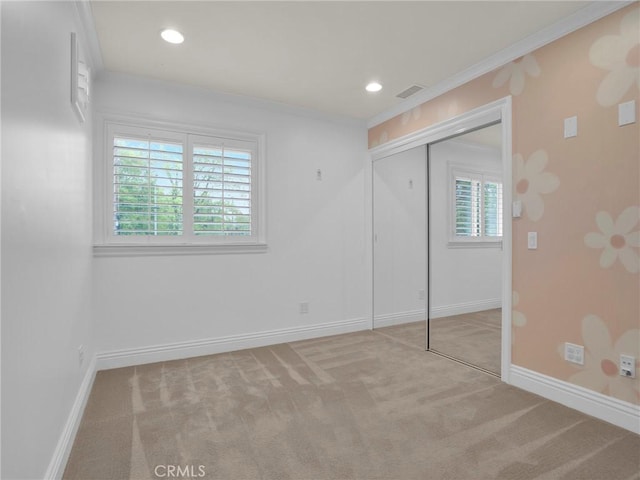 unfurnished bedroom with multiple windows, baseboards, carpet floors, crown molding, and recessed lighting