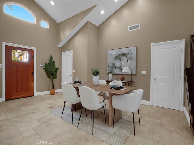 dining space with high vaulted ceiling, stone tile floors, baseboards, healthy amount of natural light, and recessed lighting