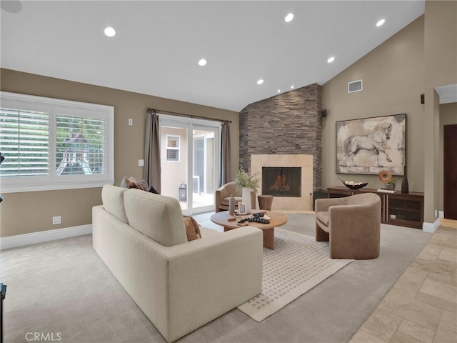 living area with baseboards, a stone fireplace, vaulted ceiling, recessed lighting, and stone tile flooring
