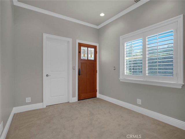 carpeted foyer entrance featuring crown molding, baseboards, and recessed lighting