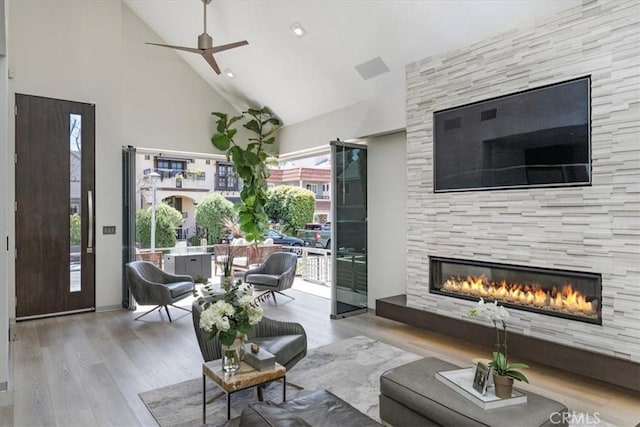 29 W Neapolitan Ln, Long Beach, CA 90803 - living room with high vaulted ceiling, a tiled fireplace, wood finished floors, and ceiling fan