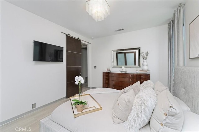 29 W Neapolitan Ln, Long Beach, CA 90803 - bedroom featuring light wood finished floors, a chandelier, a barn door, and baseboards