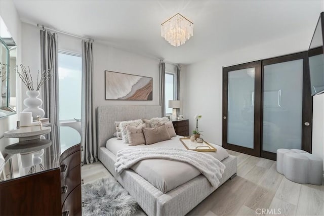 29 W Neapolitan Ln, Long Beach, CA 90803 - bedroom featuring a chandelier and light wood-type flooring