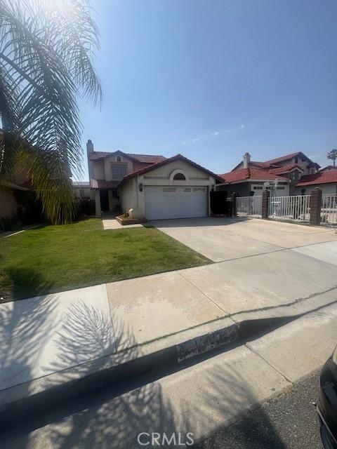 13117 Pan Am Blvd, Moreno Valley, CA 92553 - view of front of house with an attached garage, concrete driveway, and stucco siding