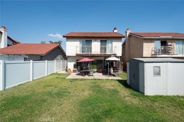 13117 Pan Am Blvd, Moreno Valley, CA 92553 - back of property featuring a balcony, a patio area, a chimney, stucco siding, and a tiled roof
