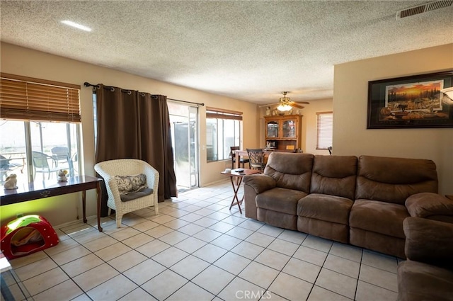 13117 Pan Am Blvd, Moreno Valley, CA 92553 - living room with light tile patterned floors, a textured ceiling, and a ceiling fan
