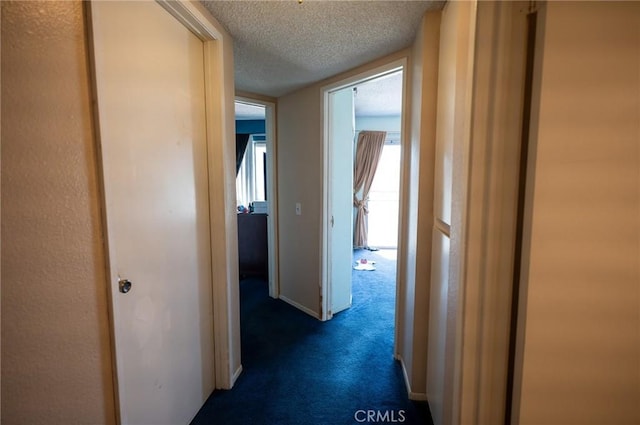 13117 Pan Am Blvd, Moreno Valley, CA 92553 - hallway featuring dark carpet and a textured ceiling